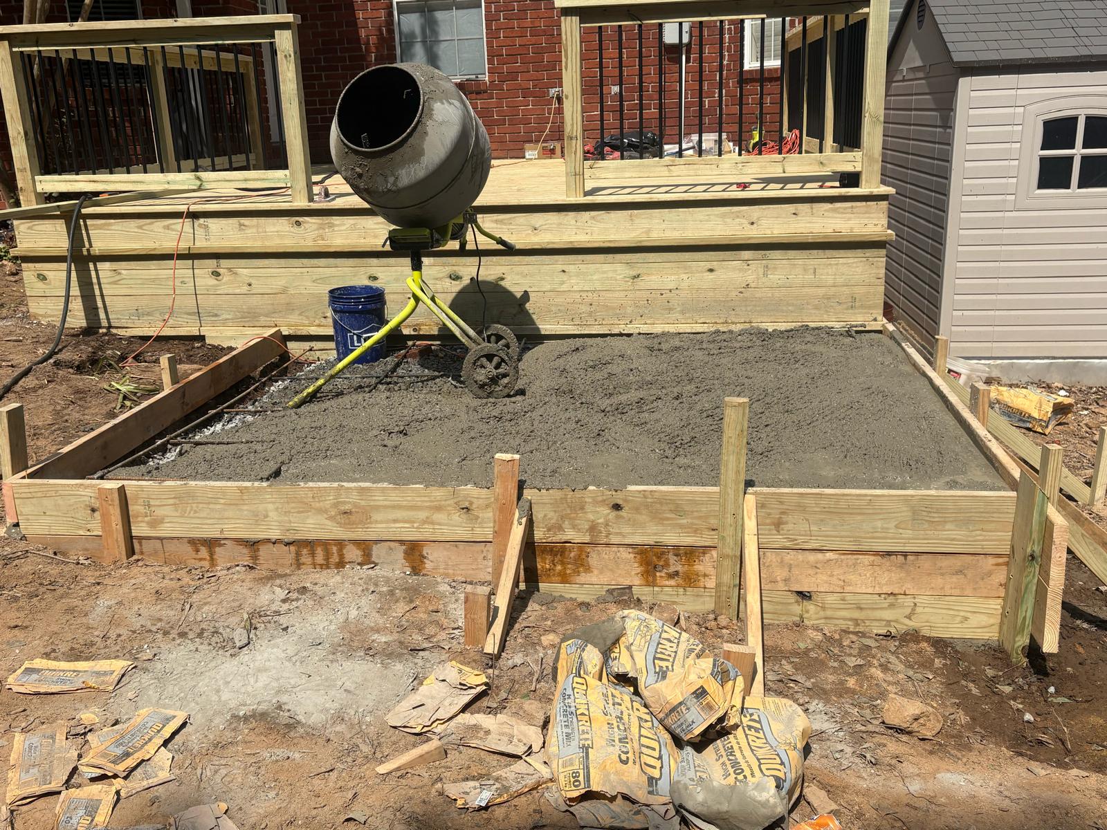 Concrete slab freshly poured behind new deck